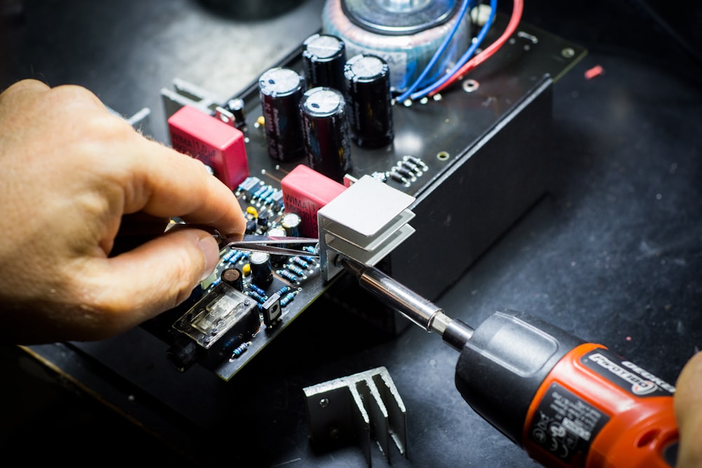 Technician soldering a circuit board